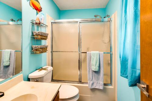 a bathroom with a shower with a toilet and a sink at Cozy Home with Fenced Backyard in Sunset Beach! in Sunset Beach