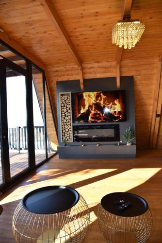 a fireplace in a living room with two tables in front of it at Villa Vista in Tirana