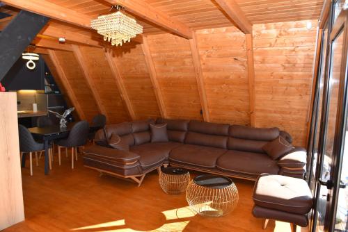 a living room with a brown couch and a table at Villa Vista in Tirana