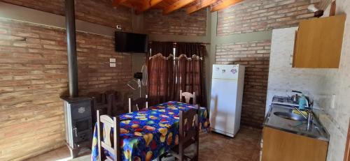 a room with two beds and a refrigerator at Cabañas El Náutico in Embalse