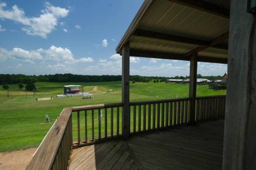 a porch of a house with a view of a field at Barn 2 Yellow Rose Canyon in Mount Enterprise