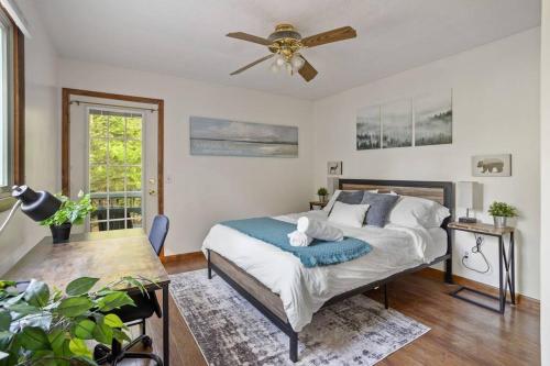 a bedroom with a bed and a ceiling fan at Mountain Oasis Hot Tub Game Room Fire Pit in Pocono Summit