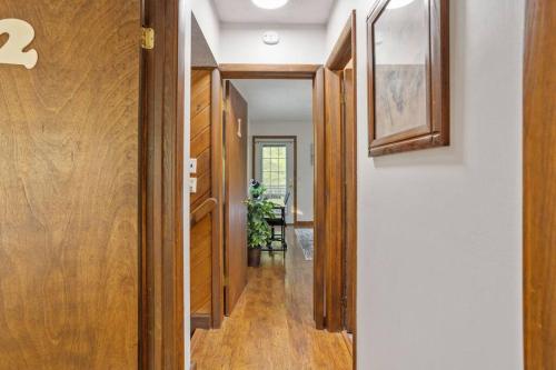 a hallway of a home with wood floors and a door at Mountain Oasis Hot Tub Game Room Fire Pit in Pocono Summit