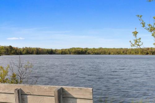 a view of a large lake with a wooden fence at Mountain Oasis Hot Tub Game Room Fire Pit in Pocono Summit