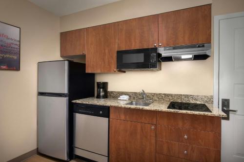 a kitchen with a refrigerator and a sink at TownePlace Suites by Marriott Portland Hillsboro in Hillsboro