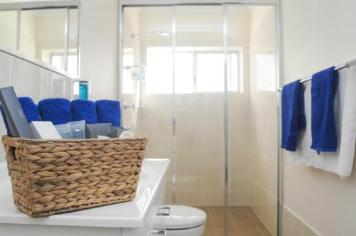 a bathroom with a toilet and a glass shower at Dubbo RSL Club Motel in Dubbo