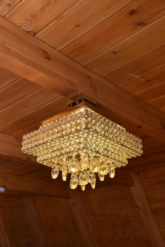 a chandelier hanging from a wooden ceiling at Villa Vista in Tirana