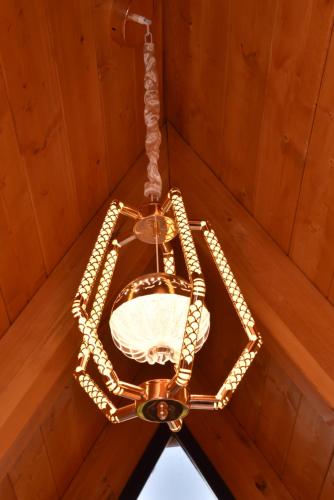 a chandelier hanging from a wooden ceiling at Villa Vista in Tirana
