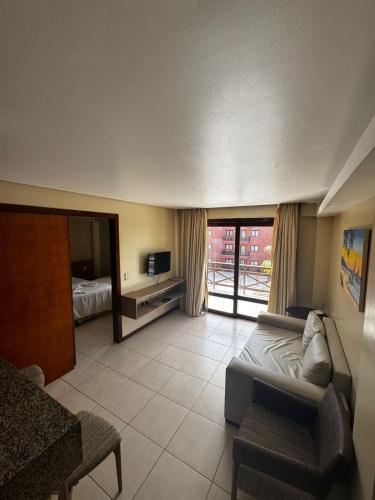 En eller flere senge i et værelse på KARIRI BEACH_CUMBUCO BOUTIQUE APARTMENTS