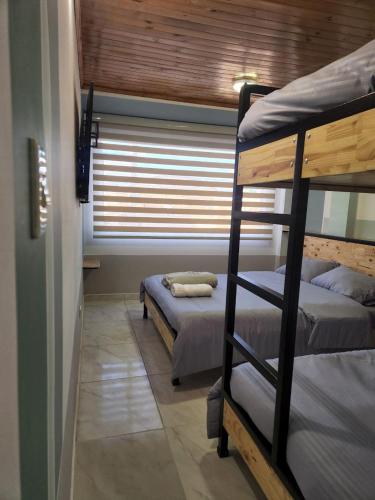 Ένα ή περισσότερα κρεβάτια σε δωμάτιο στο Conexión apartamentos y habitaciones