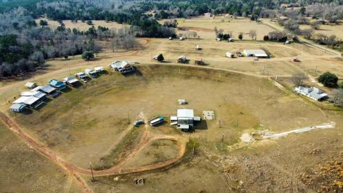 an aerial view of a farm with vehicles in a field at Redwood Cabin Yellow Rose Canyon in Mount Enterprise