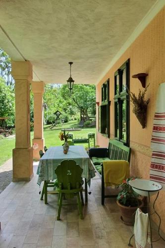 a patio with a table and chairs on a house at Secluded family friendly house Draz, Baranja - 15893 in Draž