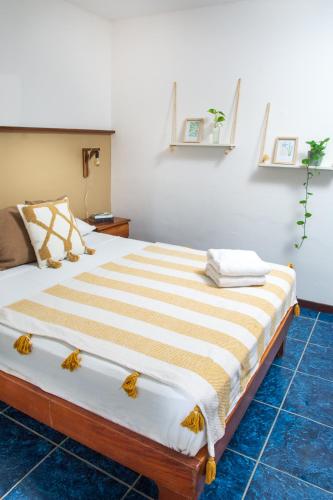 a bedroom with a large bed in a room at La Posada - Hostel in Santa Teresa Beach