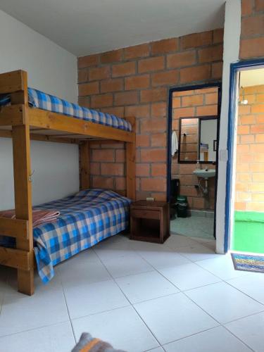a bedroom with a bunk bed and a mirror at Montaña Sanadora in Medellín