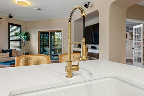 a kitchen sink with a gold faucet at Artist Retreat in North Austin - Endless Amenities in Leander