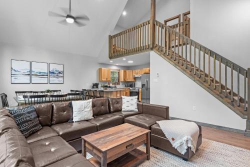a living room with a couch and a staircase at Twin Chalet 6 BDs Hot Tub Game Area and more in Albrightsville