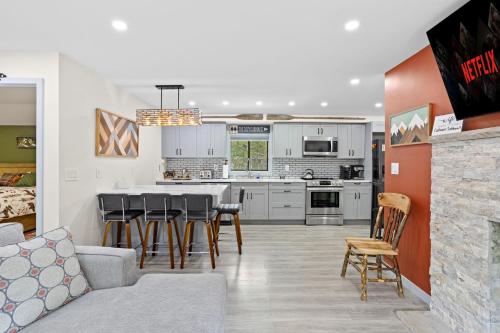 a kitchen and living room with a couch and chairs at The Cozy Cubhouse Perfect Couples Getaway in Thornhurst