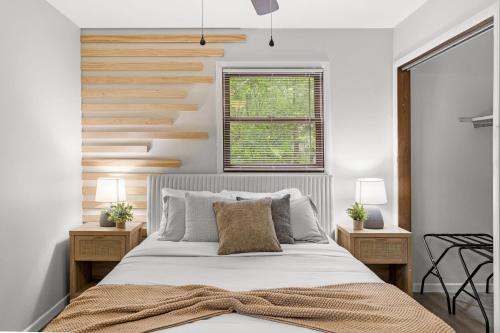 a bedroom with a bed and two night stands at Cabin in the Skye - 5 BDs Lake Harmony in Lake Harmony