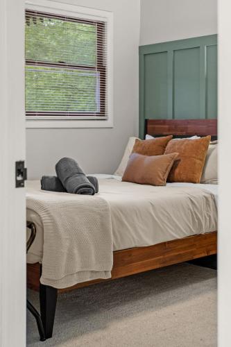 a bedroom with a large bed with pillows and a window at Cabin in the Skye - 5 BDs Lake Harmony in Lake Harmony