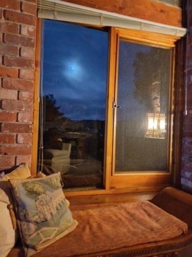 a room with a window and a couch in front at HighRoost Bed & Breakfast accomodation - rural escape in Strathalbyn