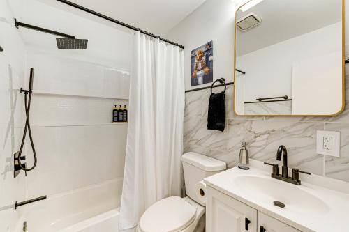 a bathroom with a sink and a toilet and a shower at Hot Tub and Game Room Long Pond Getaway! in Long Pond