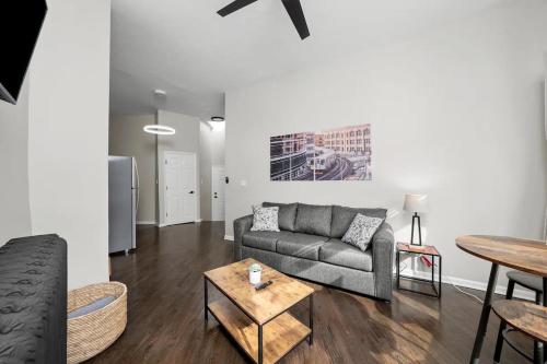 a living room with a couch and a table at Cozy 1 Bedroom Apt near Logan Sq in Chicago