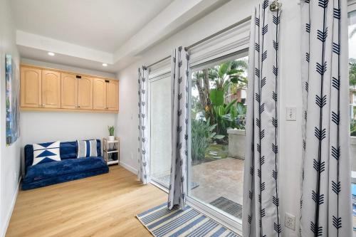 a living room with a large sliding glass door at La Costa Escape - Pool, BBQ, Gated Parking in Encinitas