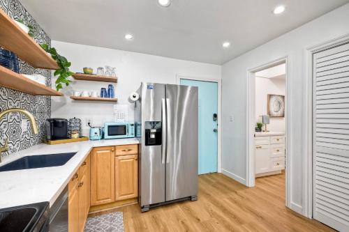 a kitchen with a stainless steel refrigerator at La Costa Escape - Pool, BBQ, Gated Parking in Encinitas