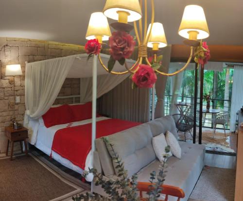 a living room with a bed and a couch at Pousada L'Amore in Siderópolis