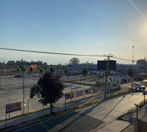 an empty parking lot with a train in a parking lot at BUIN CENTRO Departamento in Maipo