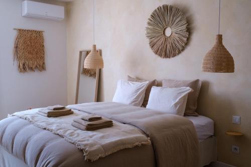 a bedroom with a bed with towels on it at AMA, suite avec baignoire balnéo et sauna privé in Avignon