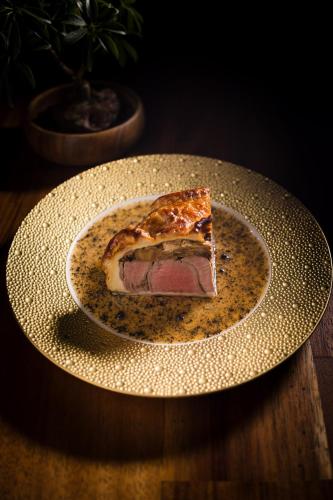 a slice of pizza on a plate on a table at Hotel Wailea, Relais & Châteaux - Adults Only in Wailea