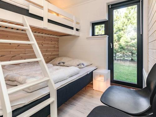 a bedroom with a bunk bed and a desk and a chair at 9 person holiday home in Væggerløse-By Traum in Marielyst