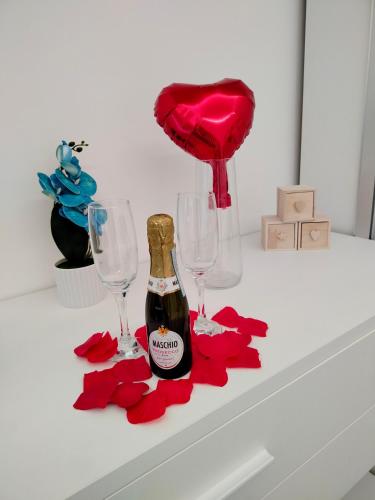 a bottle of champagne and two glasses on a table at Maruzzé luxury room in Albori