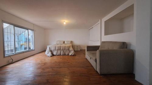 a living room with a couch and a window at Loft García in Mendoza