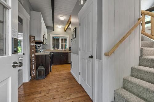 a hallway of a home with stairs and a kitchen at Metolius Cabin 5 in Camp Sherman