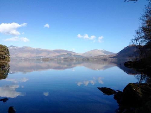 a view of a lake with mountains in the background at Limestone Lodges in Bothel