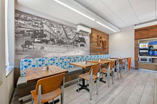 a dining room with wooden tables and chairs at Best Western Oceanfront in Jacksonville Beach