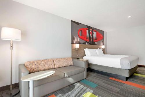 a hotel room with a bed and a couch at Best Western Oceanfront in Jacksonville Beach