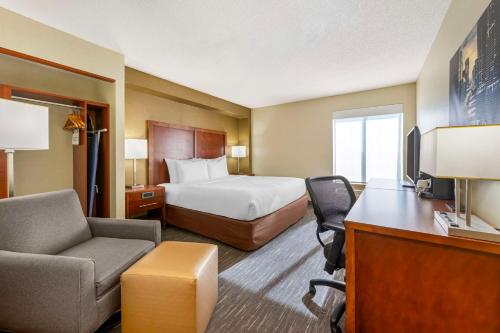 a hotel room with a bed and a desk at Best Western Chicago - Downers Grove in Downers Grove