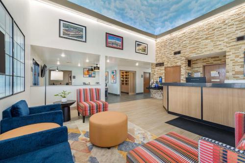 a living room with blue chairs and a lobby at Best Western Park City Wichita North in Park City
