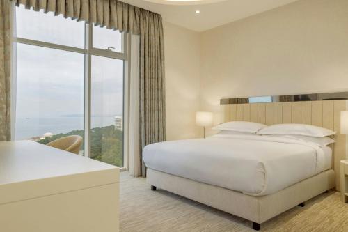 a bedroom with a large bed and a large window at Sheraton Batumi Hotel in Batumi