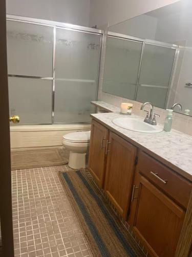 a bathroom with a sink and a toilet and a shower at Home away from home!! in Calgary