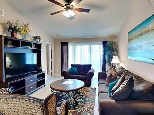 a living room with a couch and a flat screen tv at Dawn 833-Just for Fun in Galveston