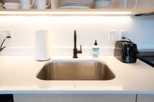 a kitchen counter with a sink and a toaster at Salt City Getaway in Salt Lake City