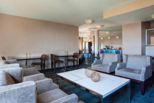 a waiting room with couches and chairs and a table at Sheraton Suites Philadelphia Airport in Philadelphia