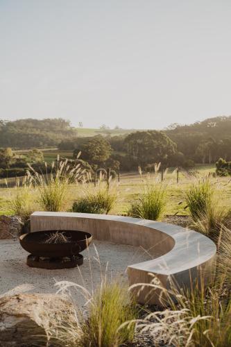 a bench in the middle of a field at Upland Farm Luxury Cabins, Denmark Western Australia in Denmark