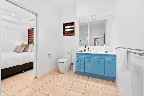 a bathroom with a blue cabinet and a sink at Three Corners Of Paradise in Clifton Beach