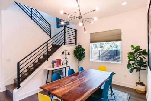 a dining room with a wooden table and chairs at Stylish 4BR with Infrared Sauna, Hot Tub, Cornhole and Cowboy Pool in Austin