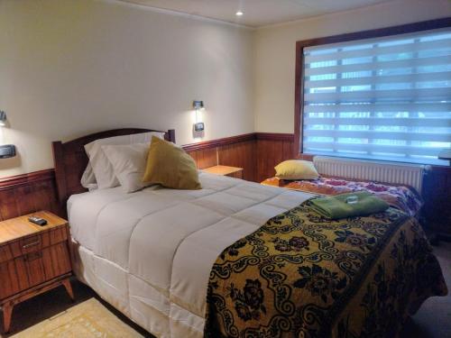 a bedroom with a bed and a large window at Tribal house in Río Seco